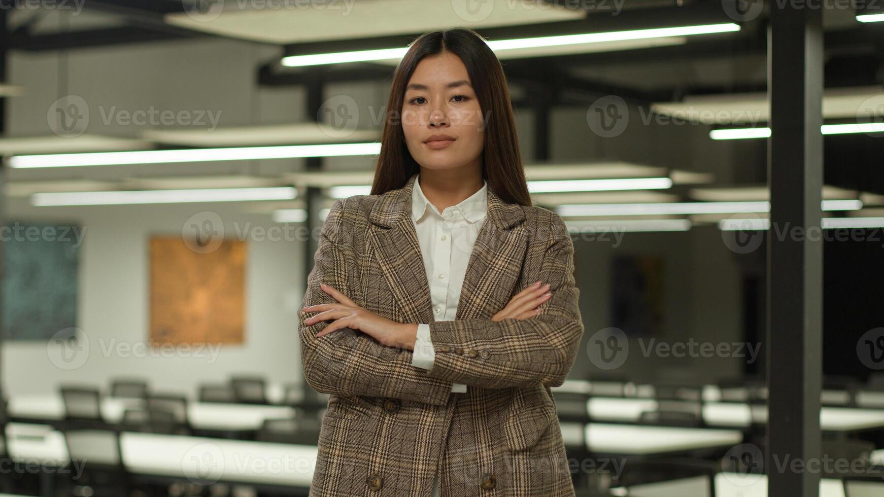Asian businesswoman young Korean business woman confident serious Chinese female employer Japanese entrepreneur lady girl posing hands crossed strong feminist manager company CEO leader in office photo