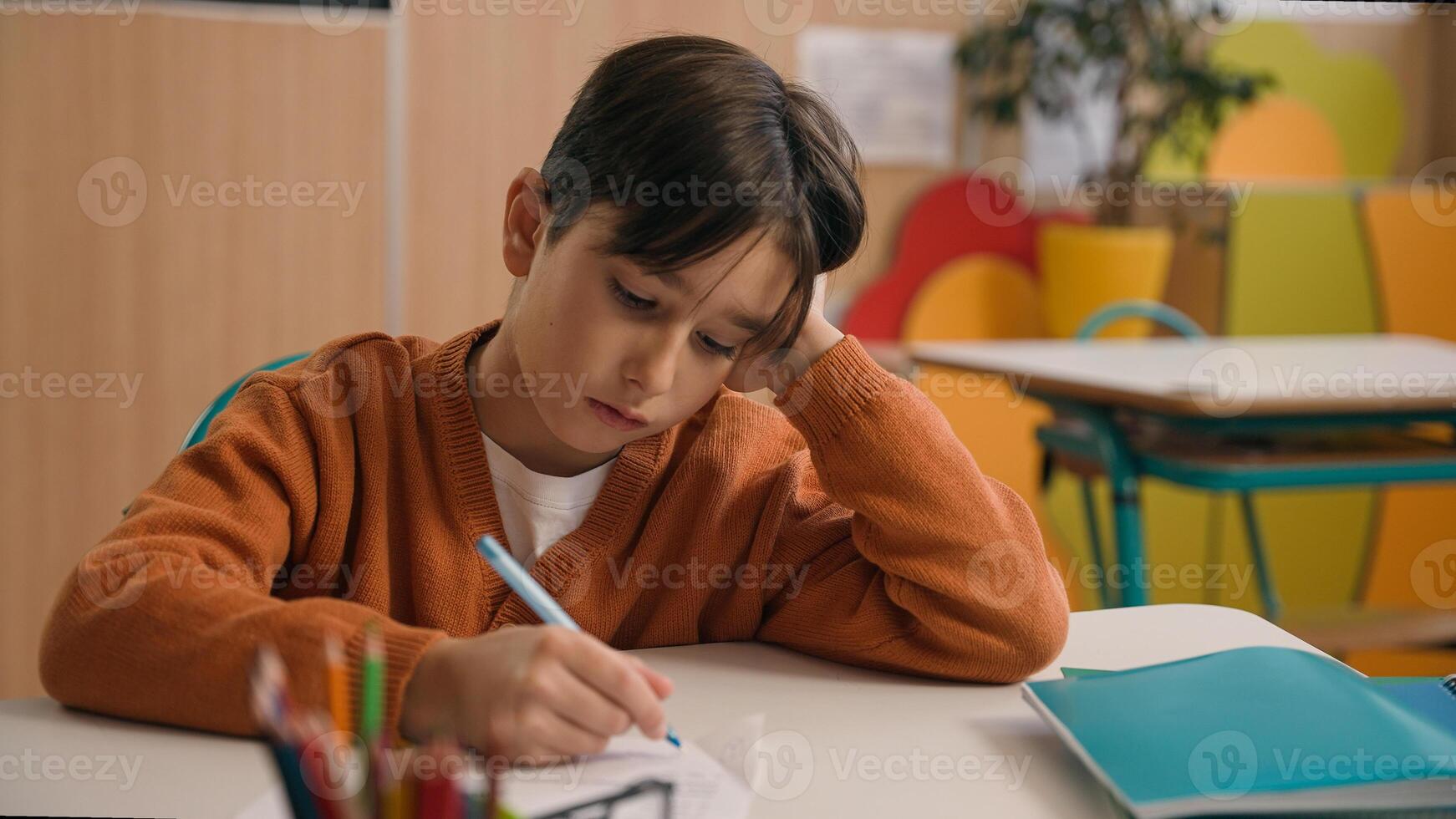 Little school boy primary schoolboy Caucasian son kid child clever smart writing task exercise at class lesson tired failure problem irritated trouble education difficulty hard studying learning study photo