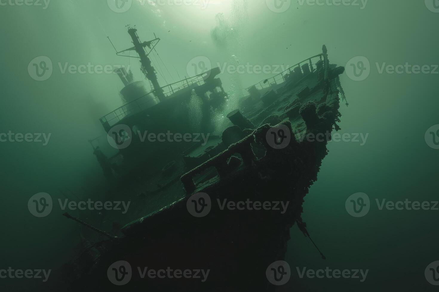 A shipwreck is seen in the ocean with a lot of debris and fish swimming around it. Scene is eerie and mysterious, as the ship is long gone and the ocean is filled with life photo