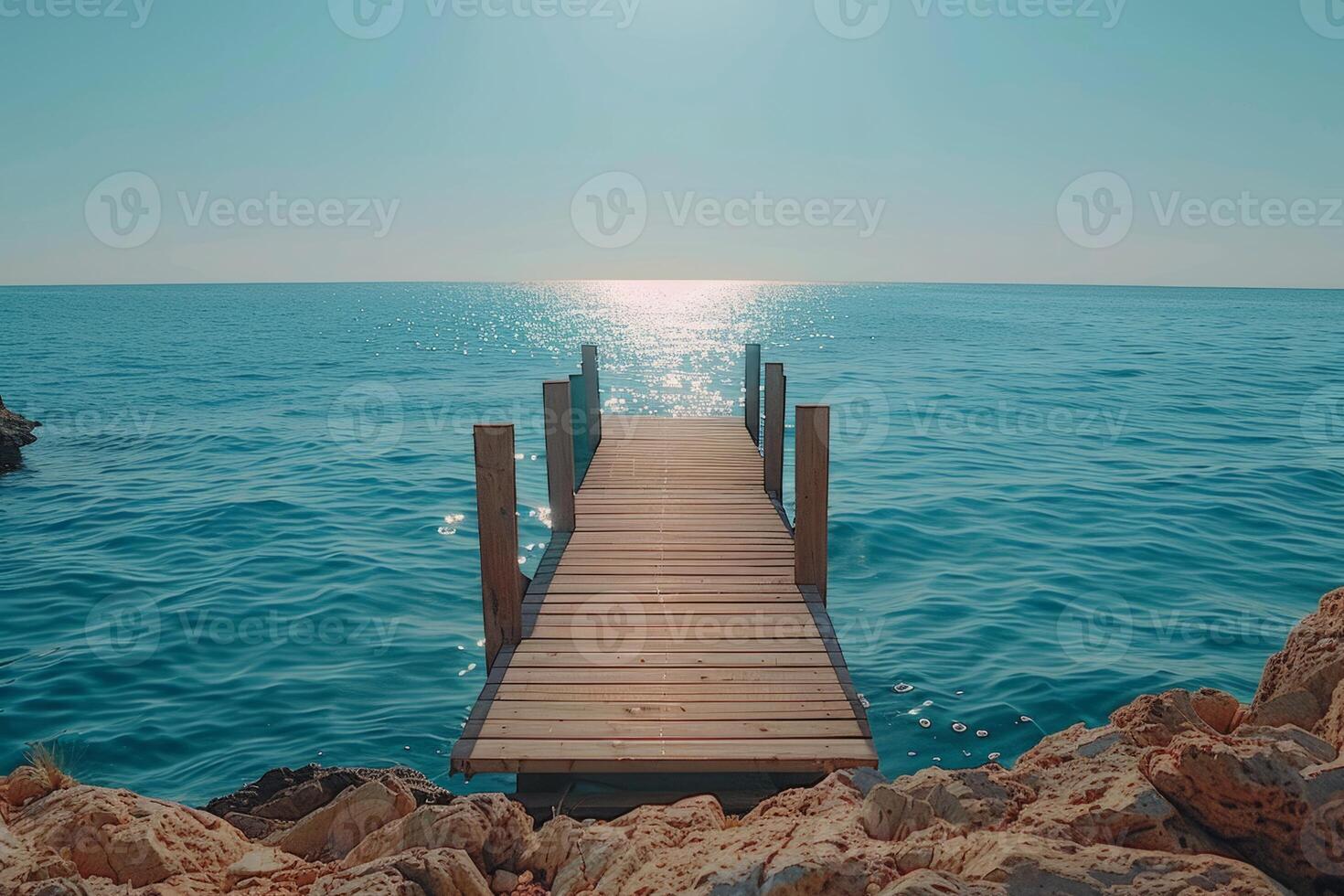 A wooden pier with a blue and white color scheme. The pier is located in the ocean and is surrounded by water. The image has a calm and peaceful mood, as it captures the beauty of the photo