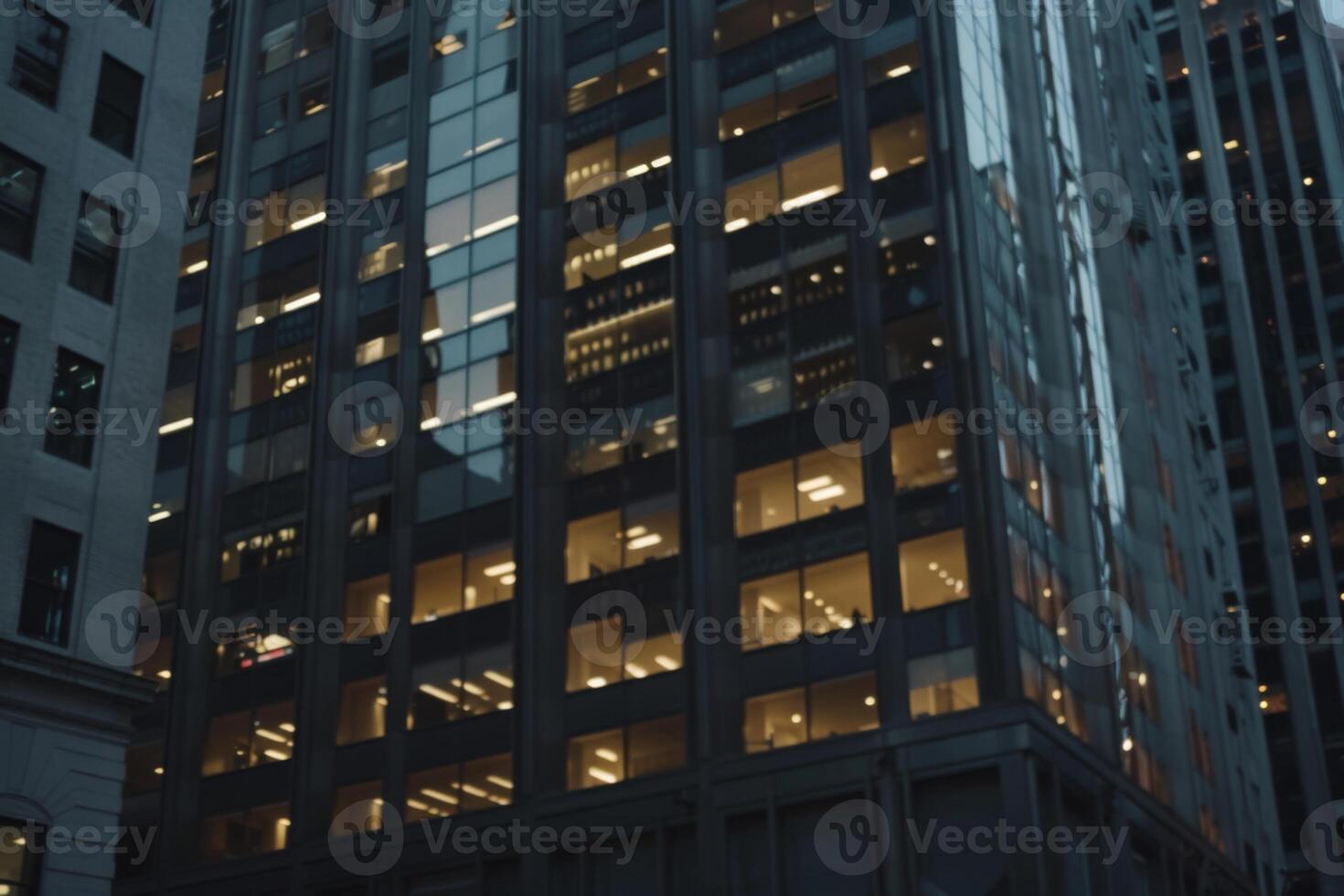 Modern office building windows lit in evening night early morning long working hours exhaustion overtime exterior urban architecture skyscraper lights tower financial sector banking hq photo