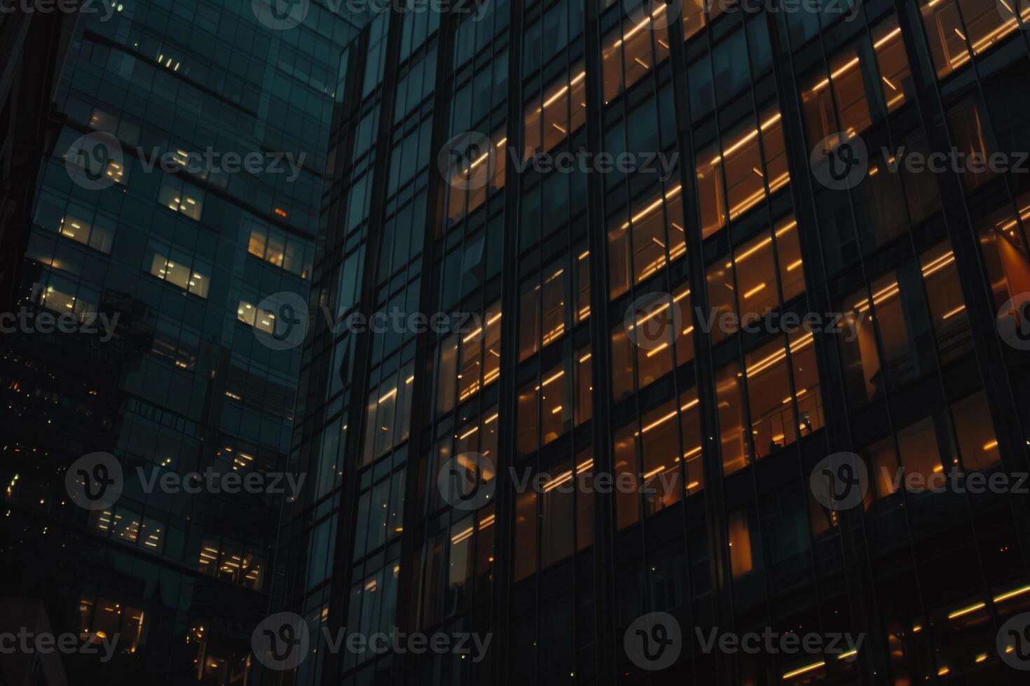 Modern office building windows lit in evening night early morning long working hours exhaustion overtime exterior urban architecture skyscraper lights tower financial sector banking hq photo