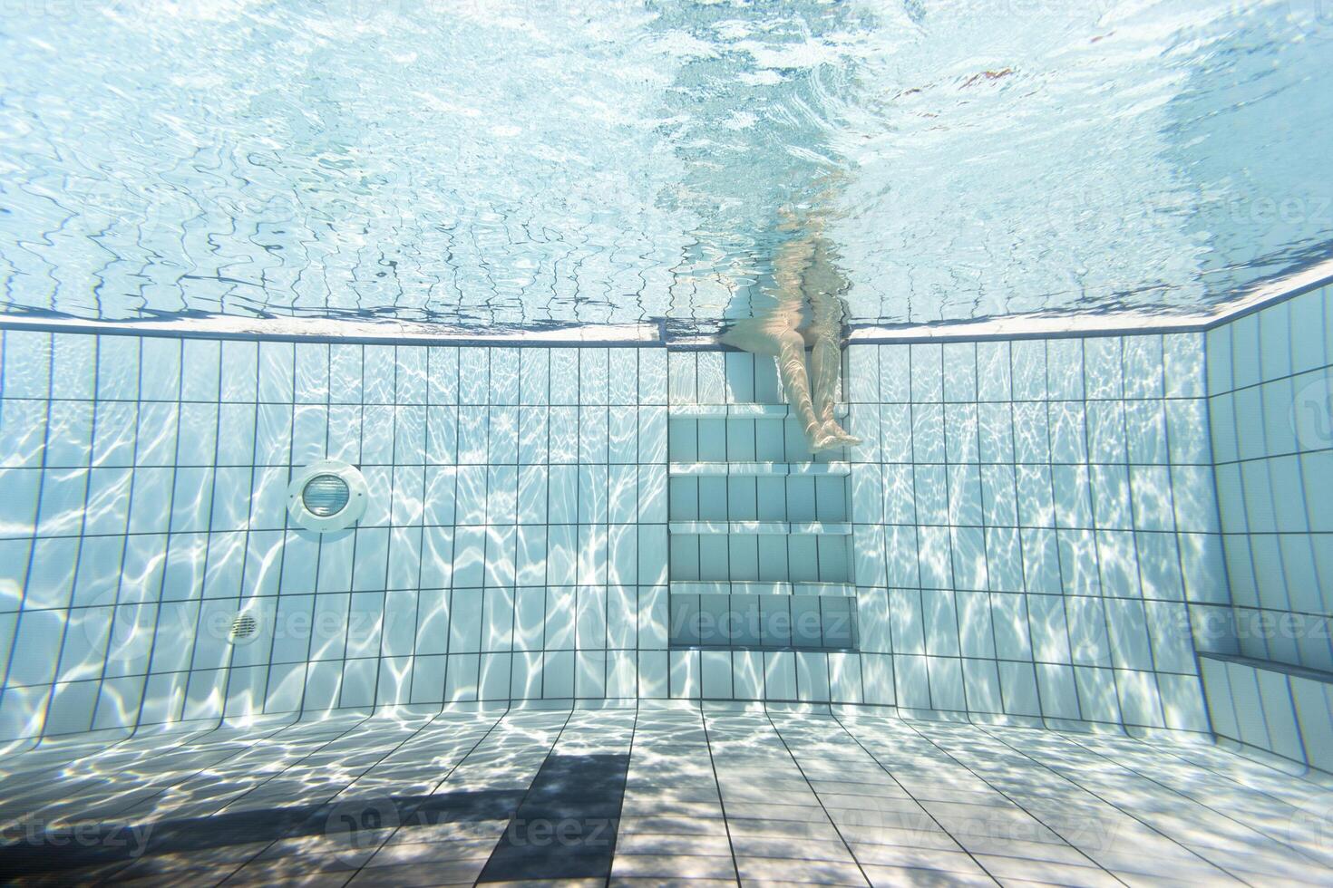 Pool view underwater swim person scene reflection floor tiles photo