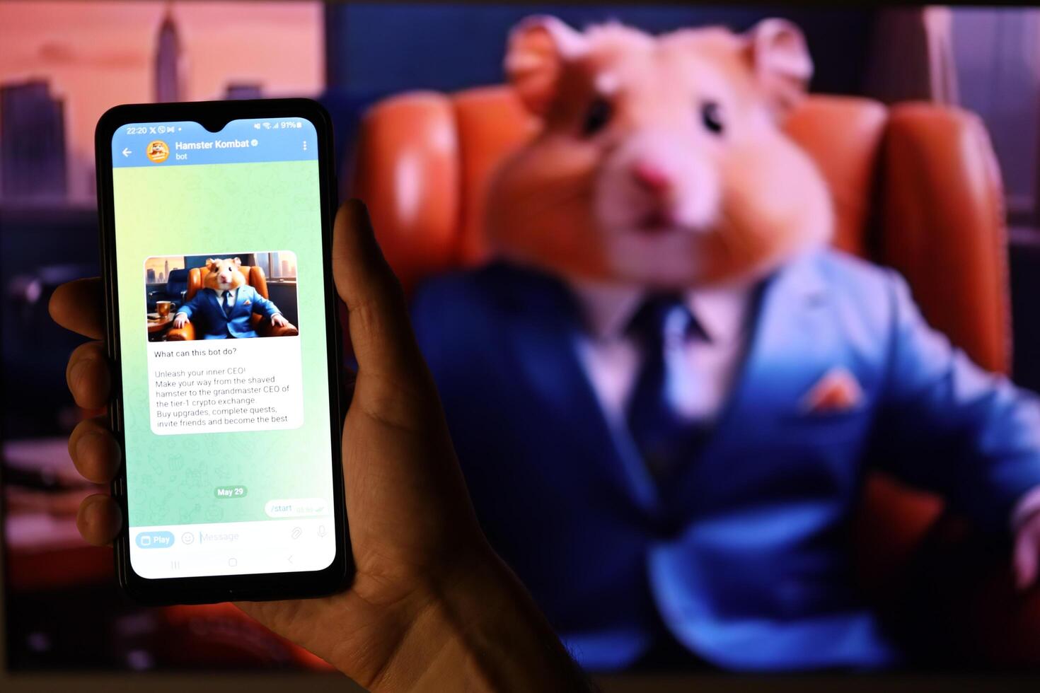KYIV, UKRAINE - APRIL 20, 2024 Hamster Kombat telegram bot on smartphone screen. Hamster Kombat is a viral Telegram-based crypto game for earn HMSTR tokens by managing virtual crypto exchange photo