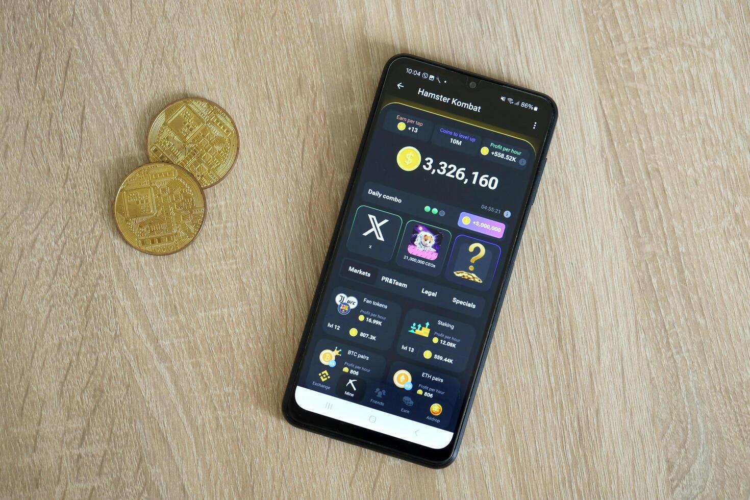 KYIV, UKRAINE - APRIL 20, 2024 Hamster Kombat telegram bot on smartphone screen. Hamster Kombat is a viral Telegram crypto game for earn HMSTR tokens by managing virtual crypto exchange photo