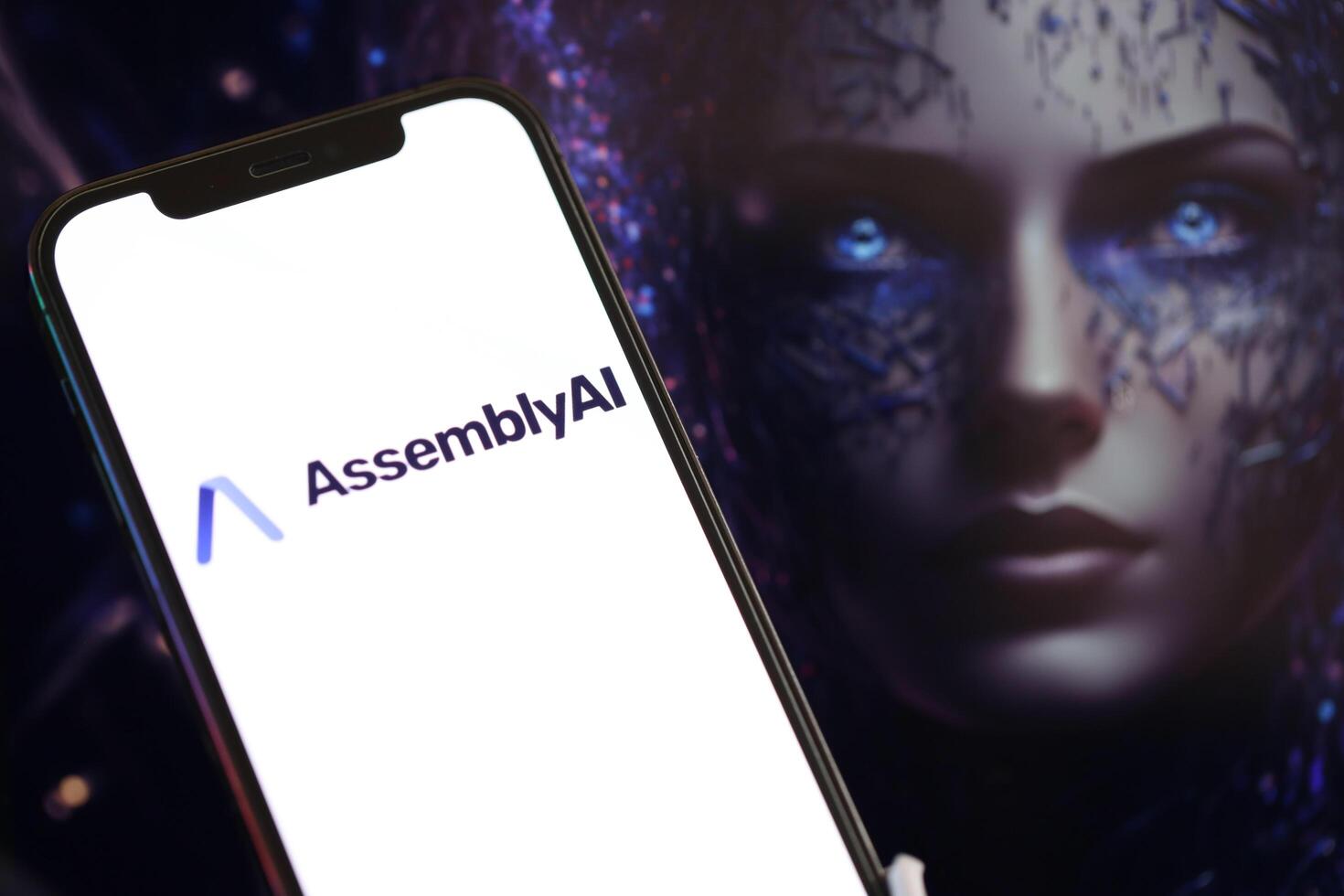 KYIV, UKRAINE - MARCH 17, 2024 AssemblyAI logo on iPhone display screen with background of artificial intelligence futuristic image photo