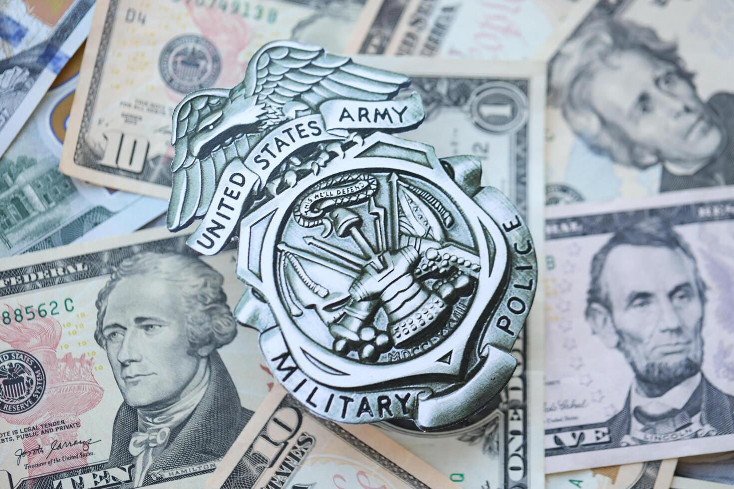 KYIV, UKRAINE - MARCH 9, 2024 US Army Military Police badge on many US dollar bills photo