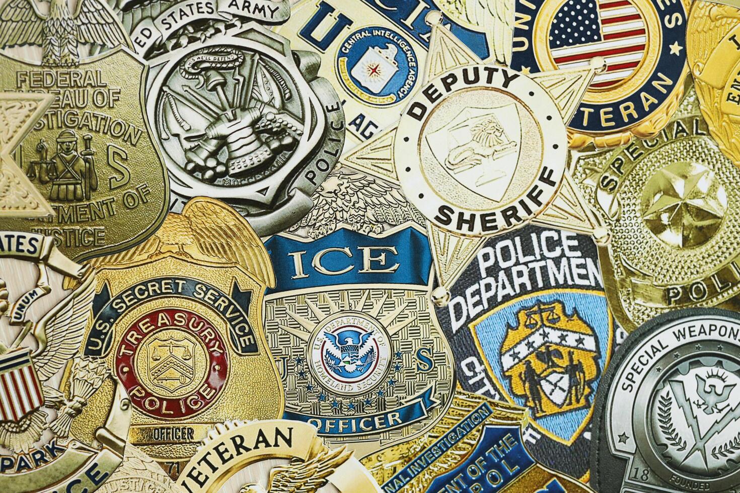 KYIV, UKRAINE - MARCH 9, 2024 Badges of different United States police departments printed on paper photo