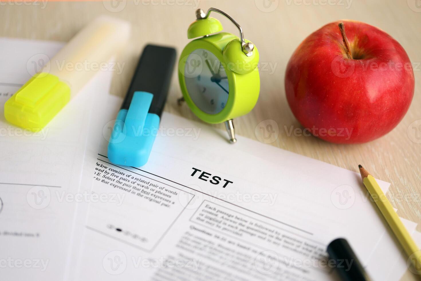 Blank educational test for students lies on table in classroom with pen photo