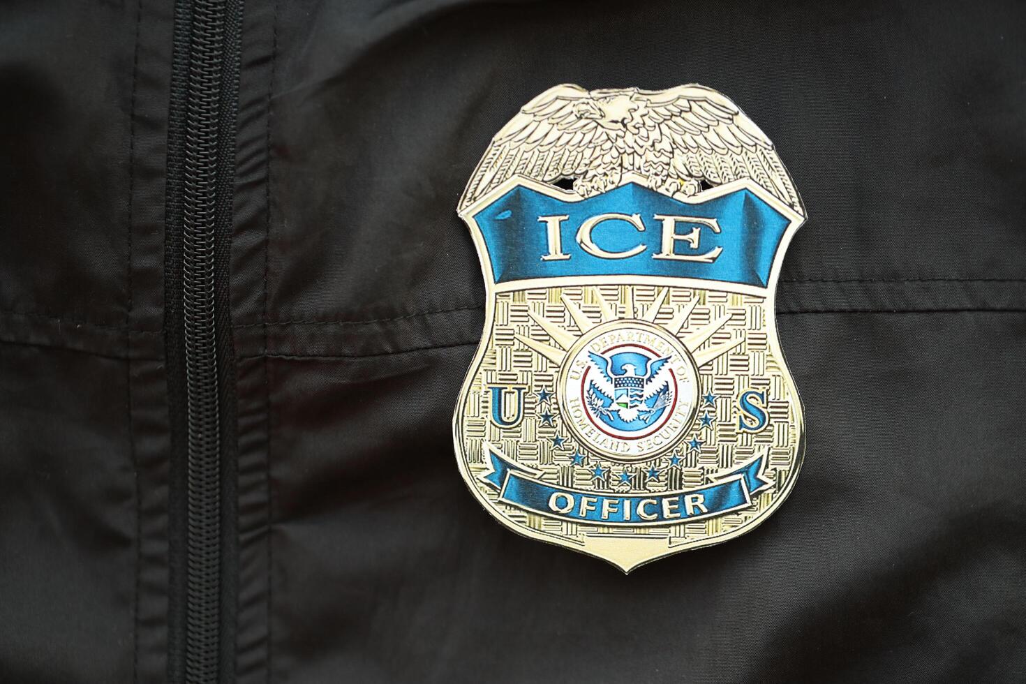 KYIV, UKRAINE - MARCH 9, 2024 US ICE Officer badge on black jacket uniform photo
