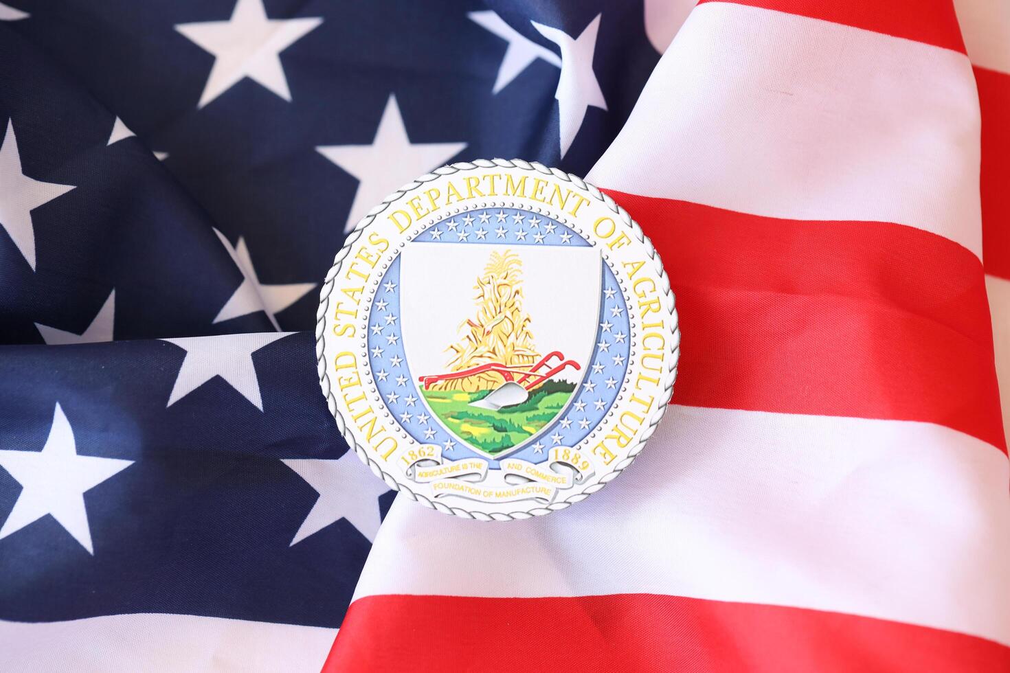 KYIV, UKRAINE - MARCH 9, 2024 US Department of Agriculture seal on United States of America flag photo