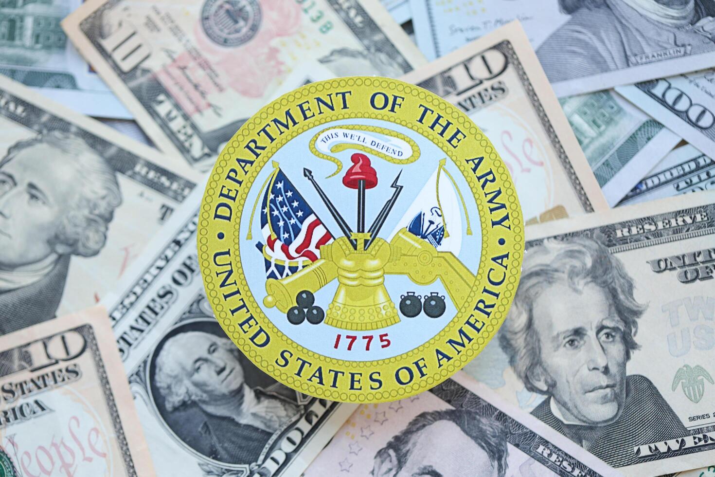 KYIV, UKRAINE - MARCH 9, 2024 US Department of Army seal on many US dollar bills photo