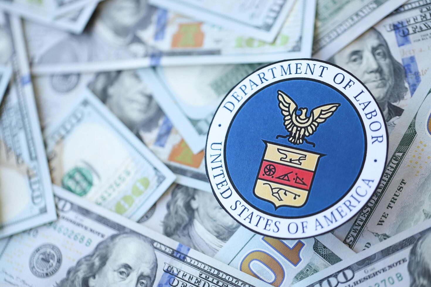 KYIV, UKRAINE - MARCH 9, 2024 US Department of Labor seal on many US hundred dollar bills photo