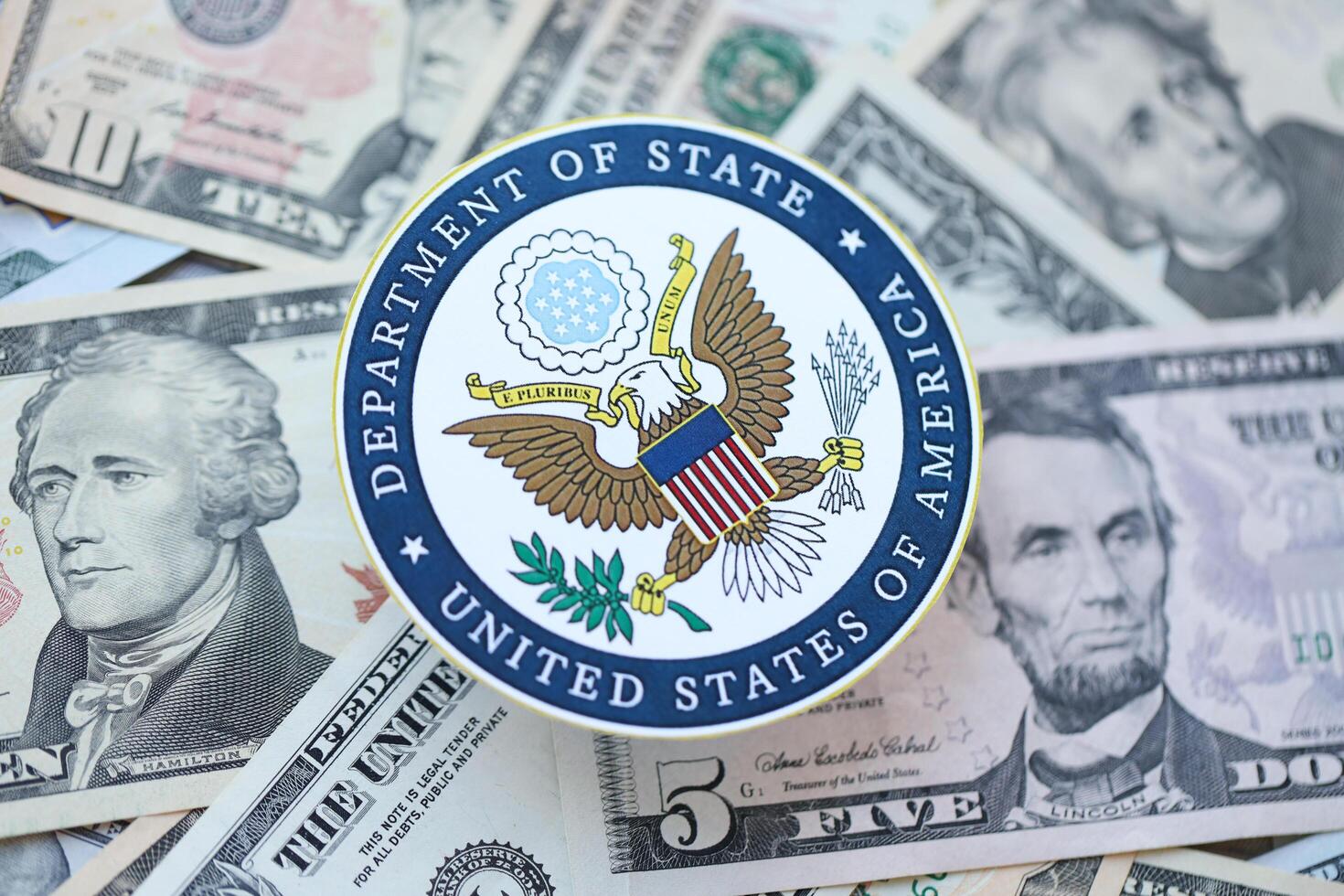 KYIV, UKRAINE - MARCH 9, 2024 US Department of State seal on many US dollar bills photo