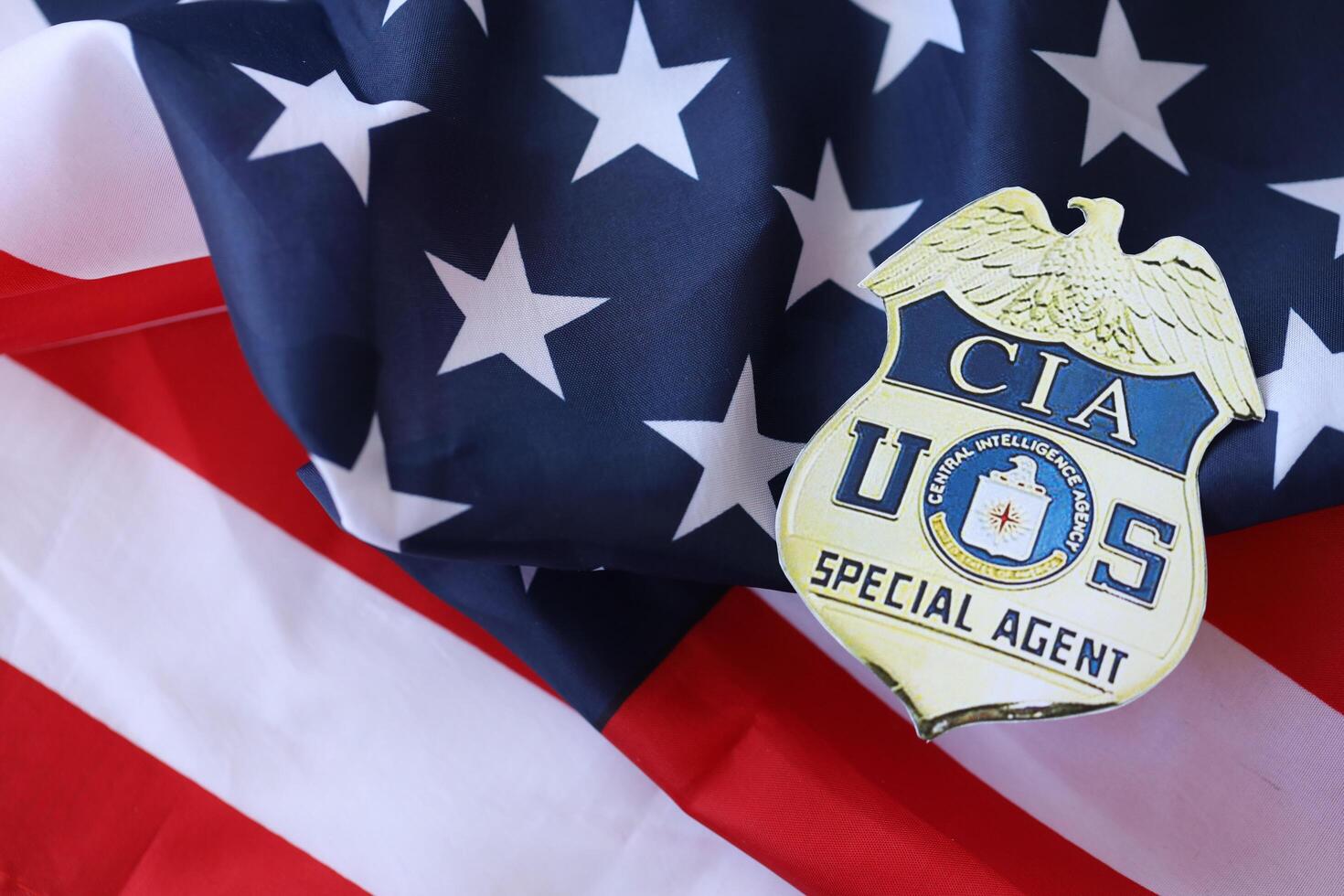KYIV, UKRAINE - MARCH 9, 2024 US CIA Central Intelligence Agency badge on United States of America flag photo