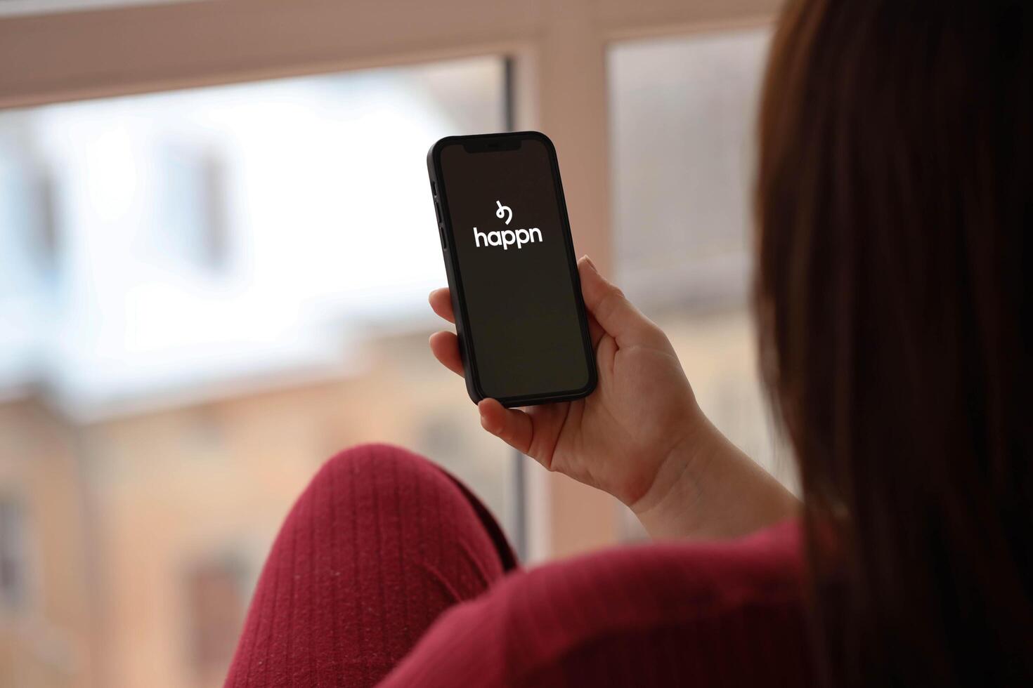 KYIV, UKRAINE - FEBRUARY 23, 2024 Happn logo of famous dating website or app on iPhone display photo