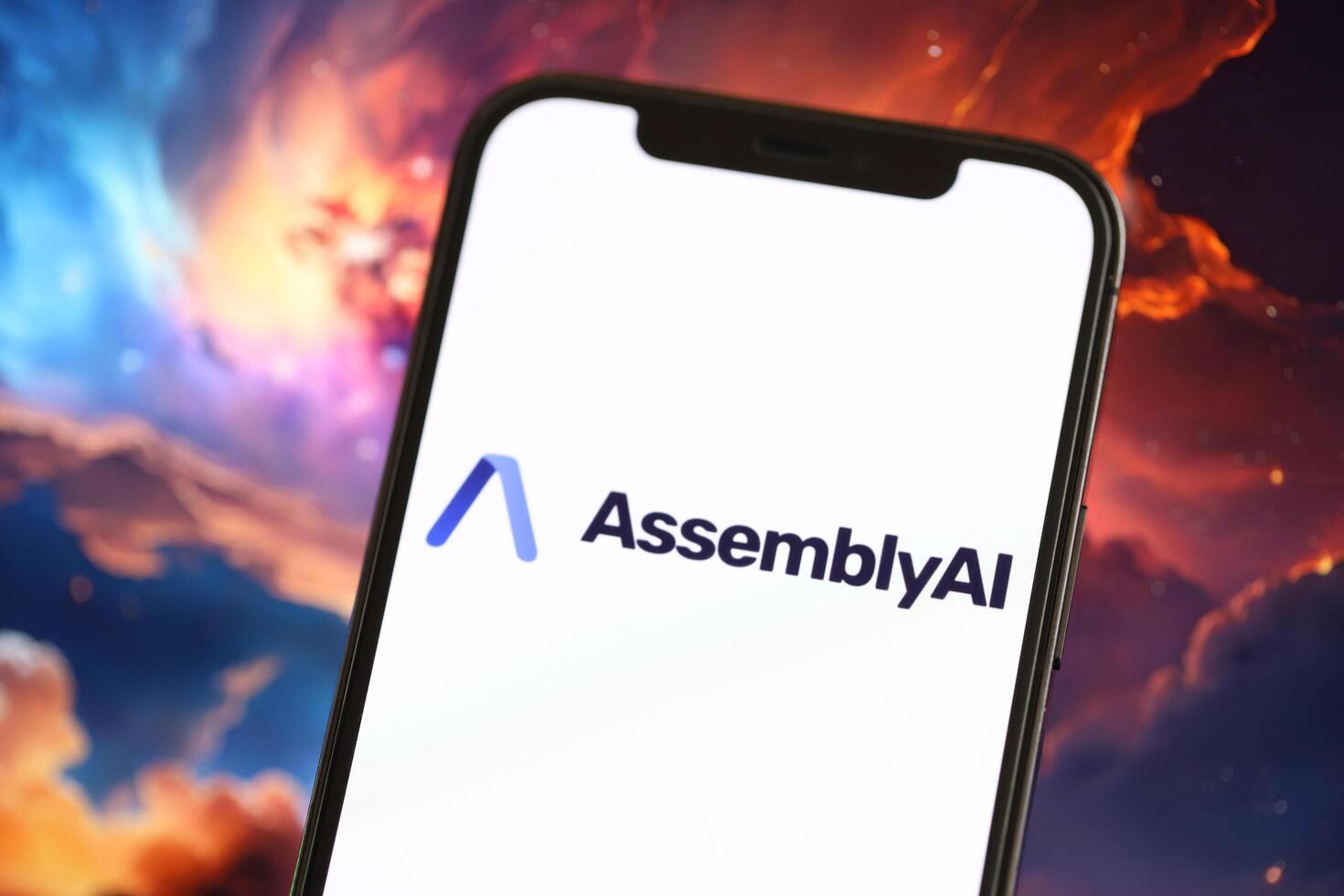 KYIV, UKRAINE - MARCH 17, 2024 AssemblyAI logo on iPhone display screen with background of artificial intelligence futuristic image photo