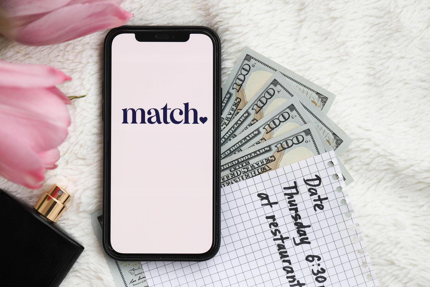 KYIV, UKRAINE - FEBRUARY 23, 2024 Match logo of famous dating website or app on iPhone display photo