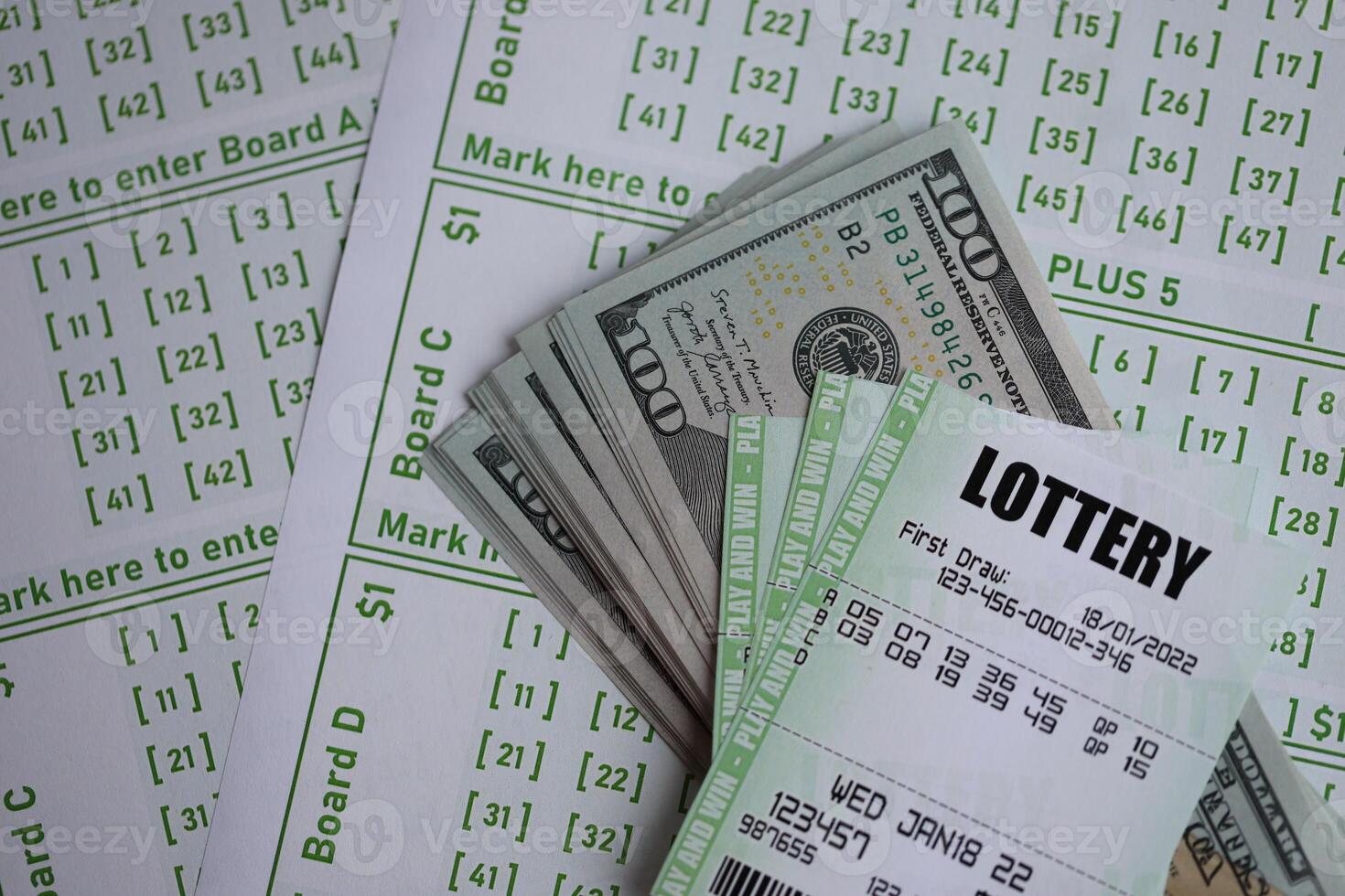 Green lottery tickets and US money bills on blank with numbers for playing lottery photo