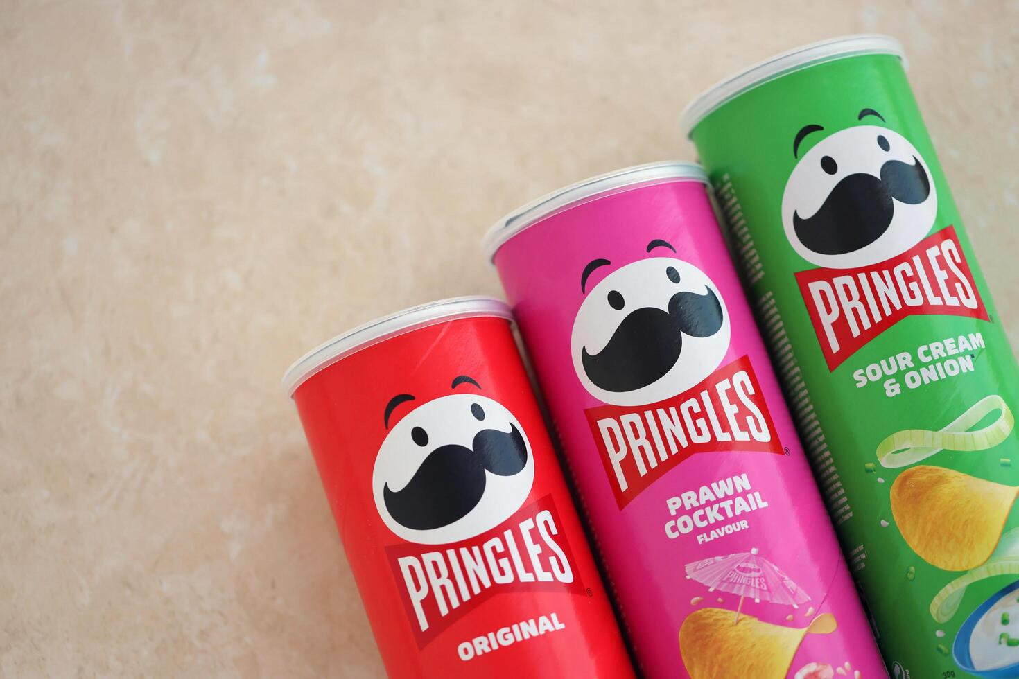 KYIV, UKRAINE - 4 MAY, 2023 Many pringles tubes of chips with various flavours photo