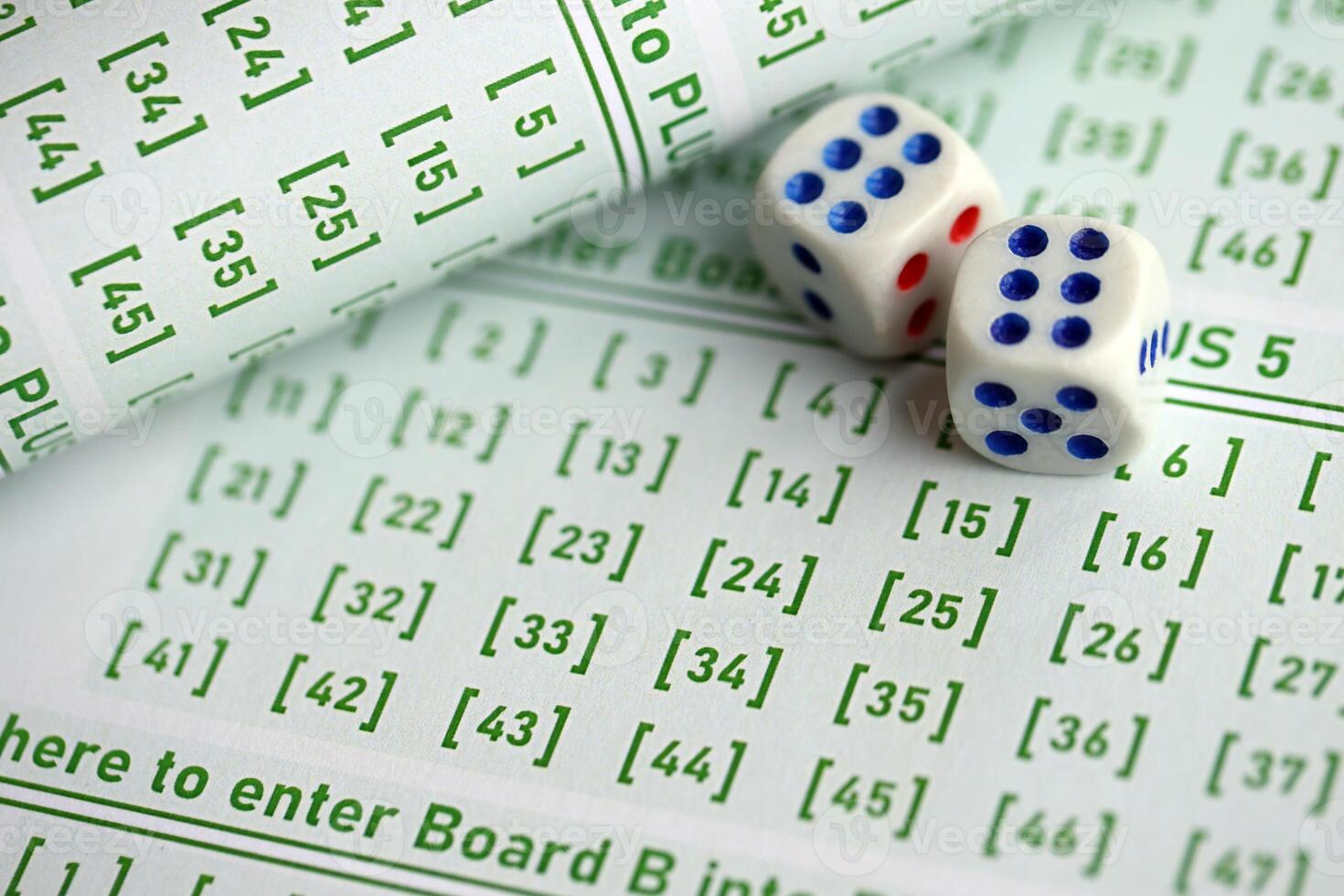 Lottery tickets and dice on blank bills with numbers for playing lottery photo