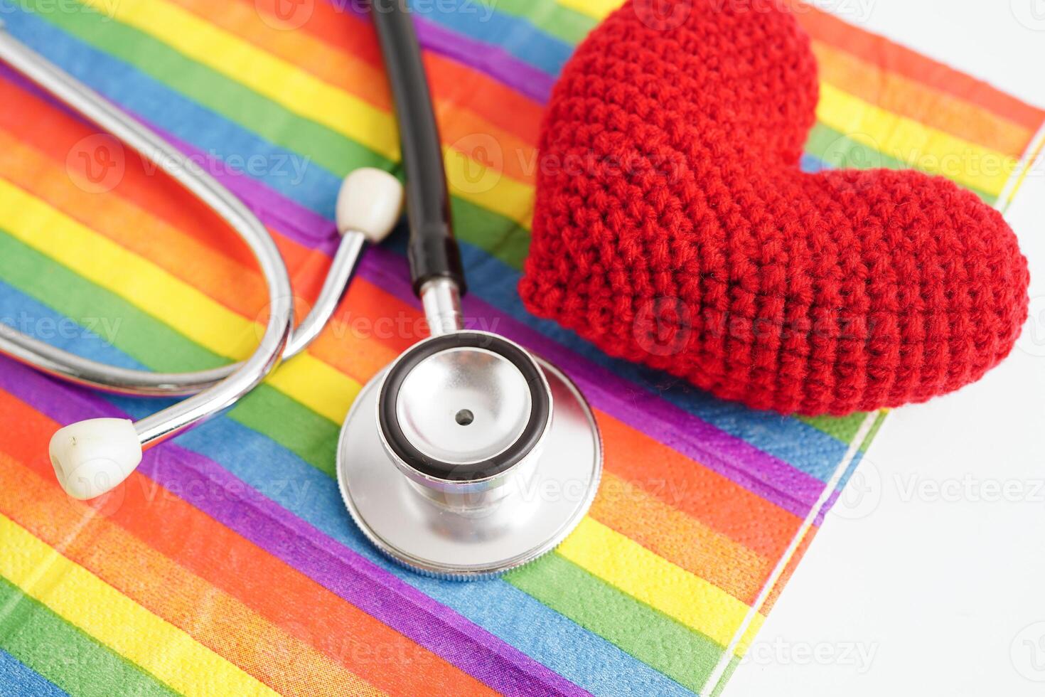 LGBT symbol, Stethoscope with red heart on rainbow flag, rights and gender equality, LGBT Pride Month in June. photo