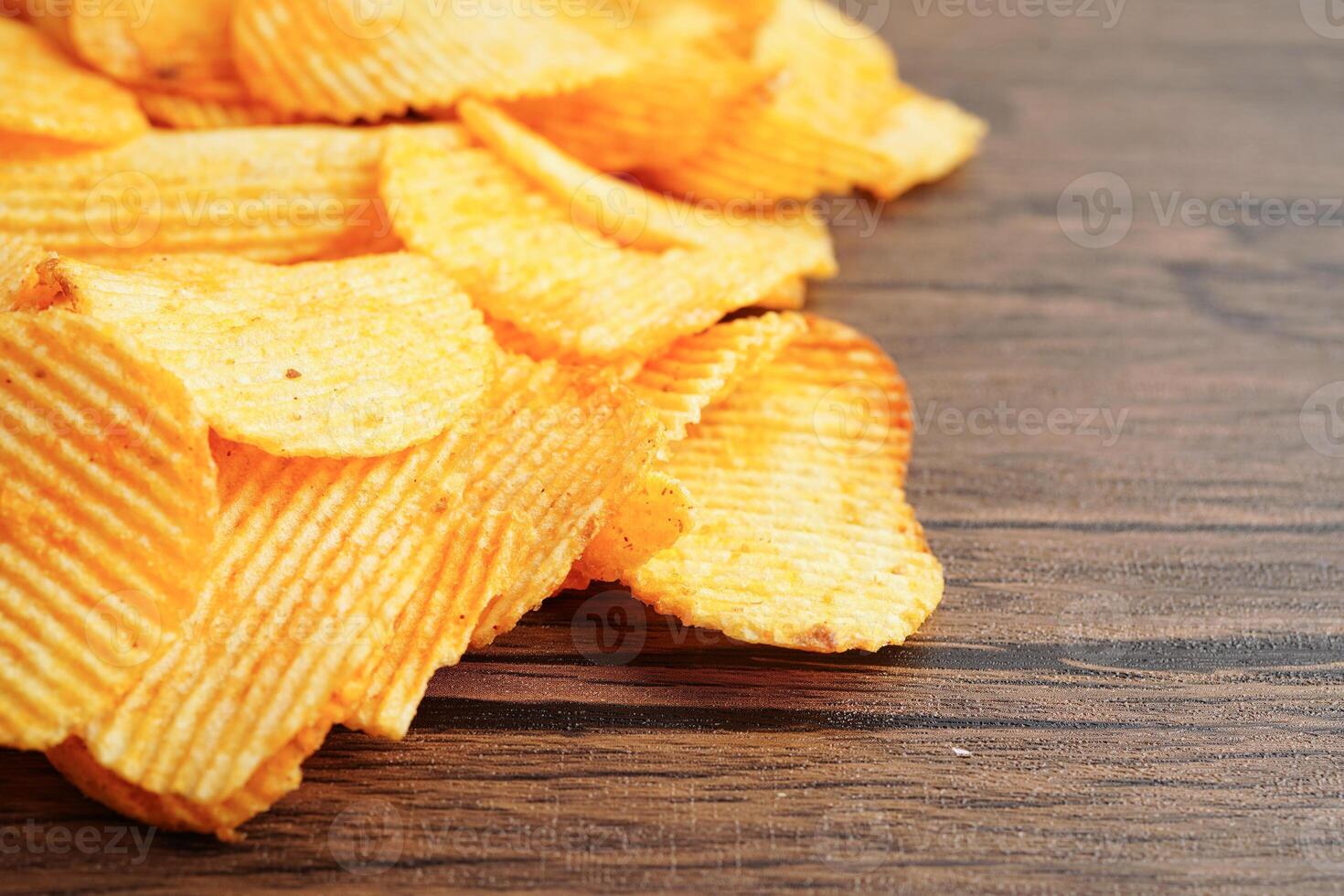 Potato chips , delicious BBQ seasoning spicy for crips, thin slice deep fried snack fast food. photo
