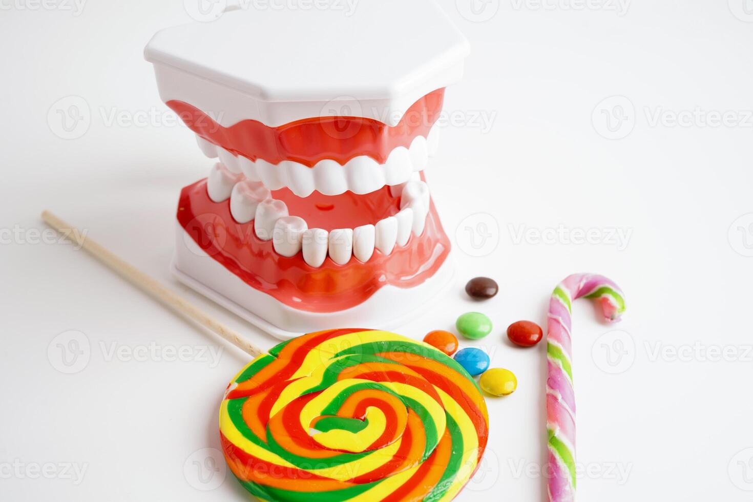 Tooth decay with sweet sugar candy, bad food for dental health care. photo