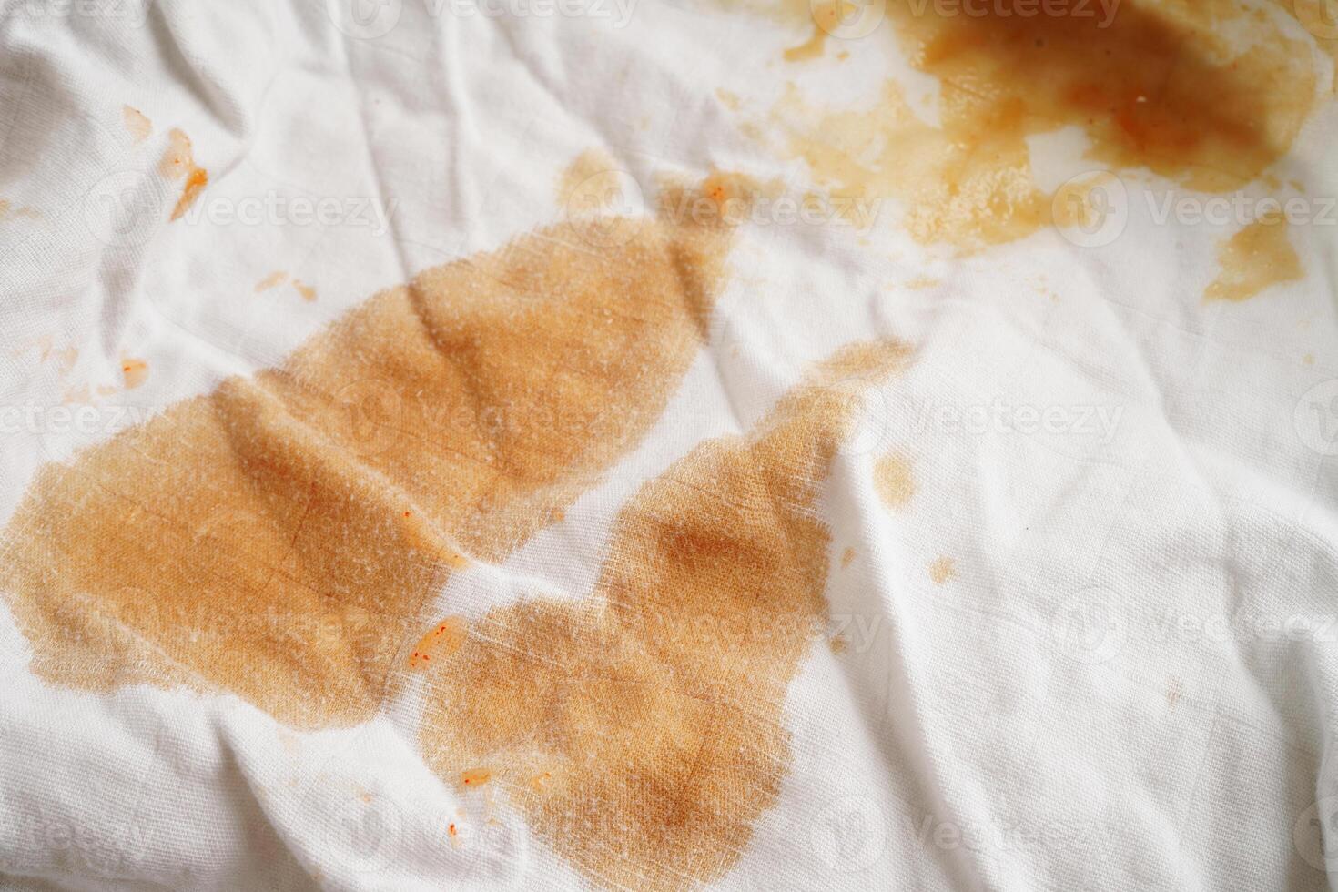 Dirty tomato sauce stain or ketchup on cloth to wash with washing powder, cleaning housework concept. photo