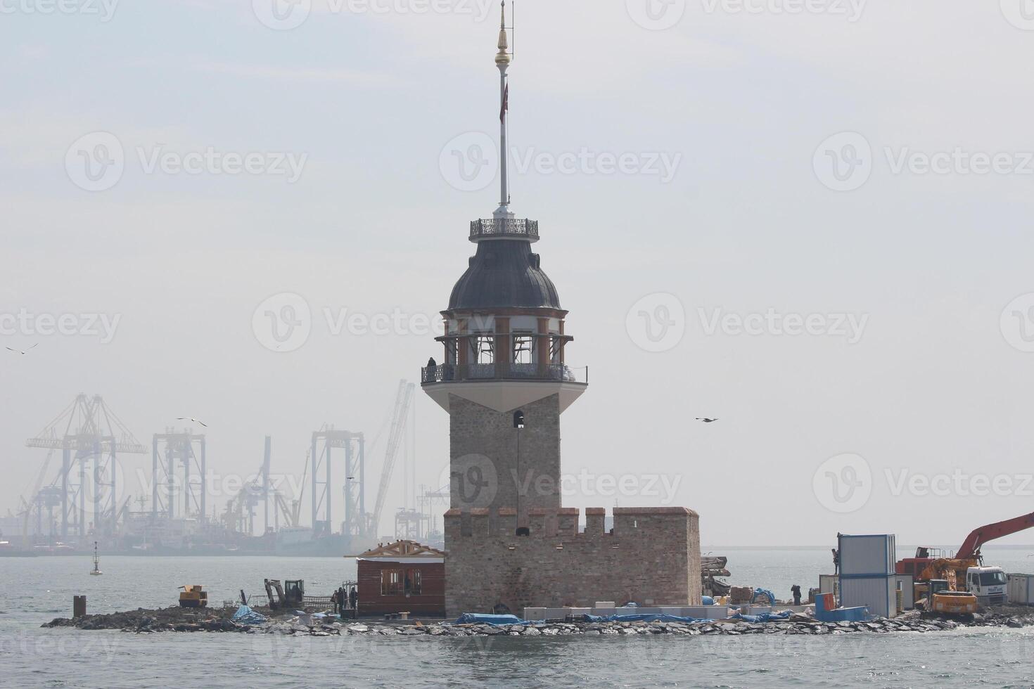 tower of girl in istanbul , turkey in middle of sea with cloudy sky photo