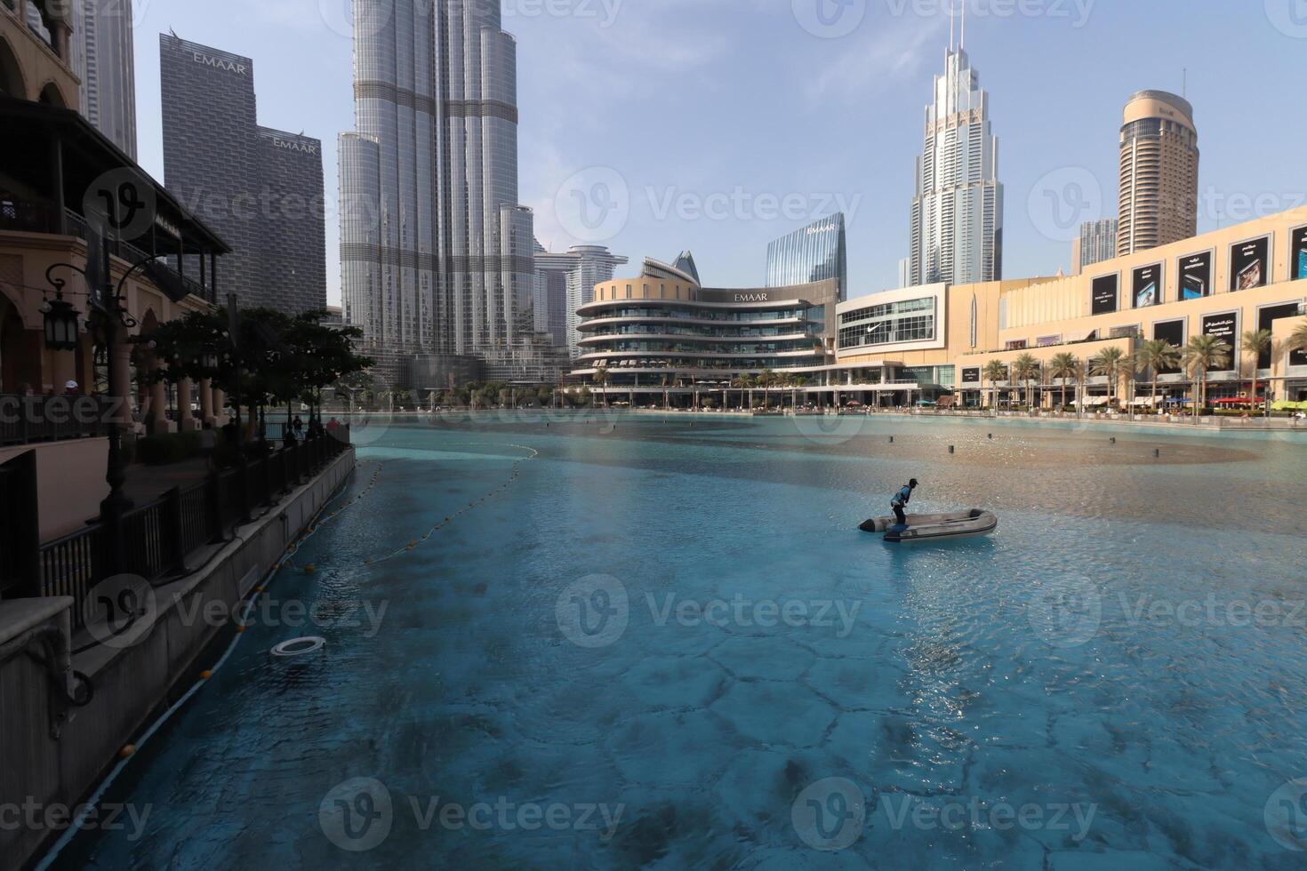 uae, dubai , 1th December 2022 a picture of the burj khalifa with towers and buildings in the night with small lake photo