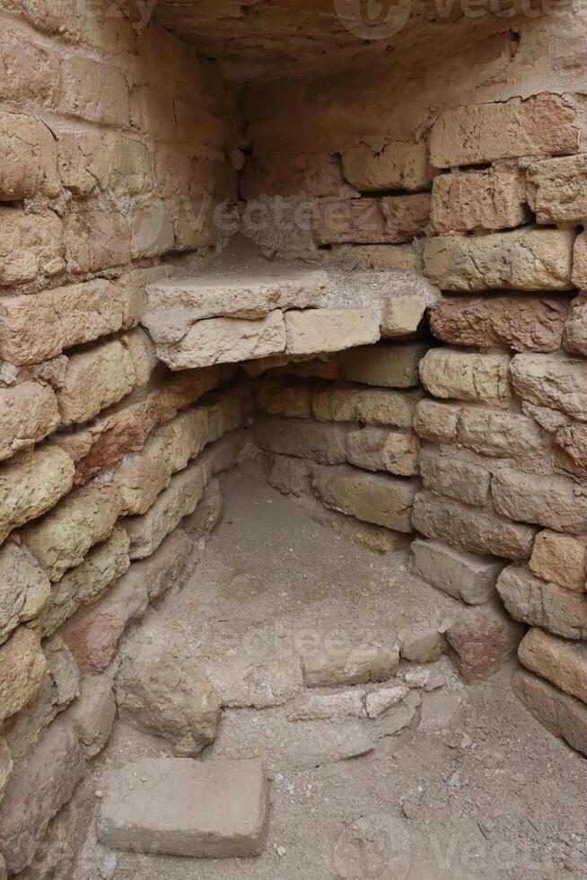 old shelves 2025 bc . shelves below the shelves without restoration , built of bricks in the house of the prophet of god , abraham, may god bless him and grant him peace in ur in Iraq . photo