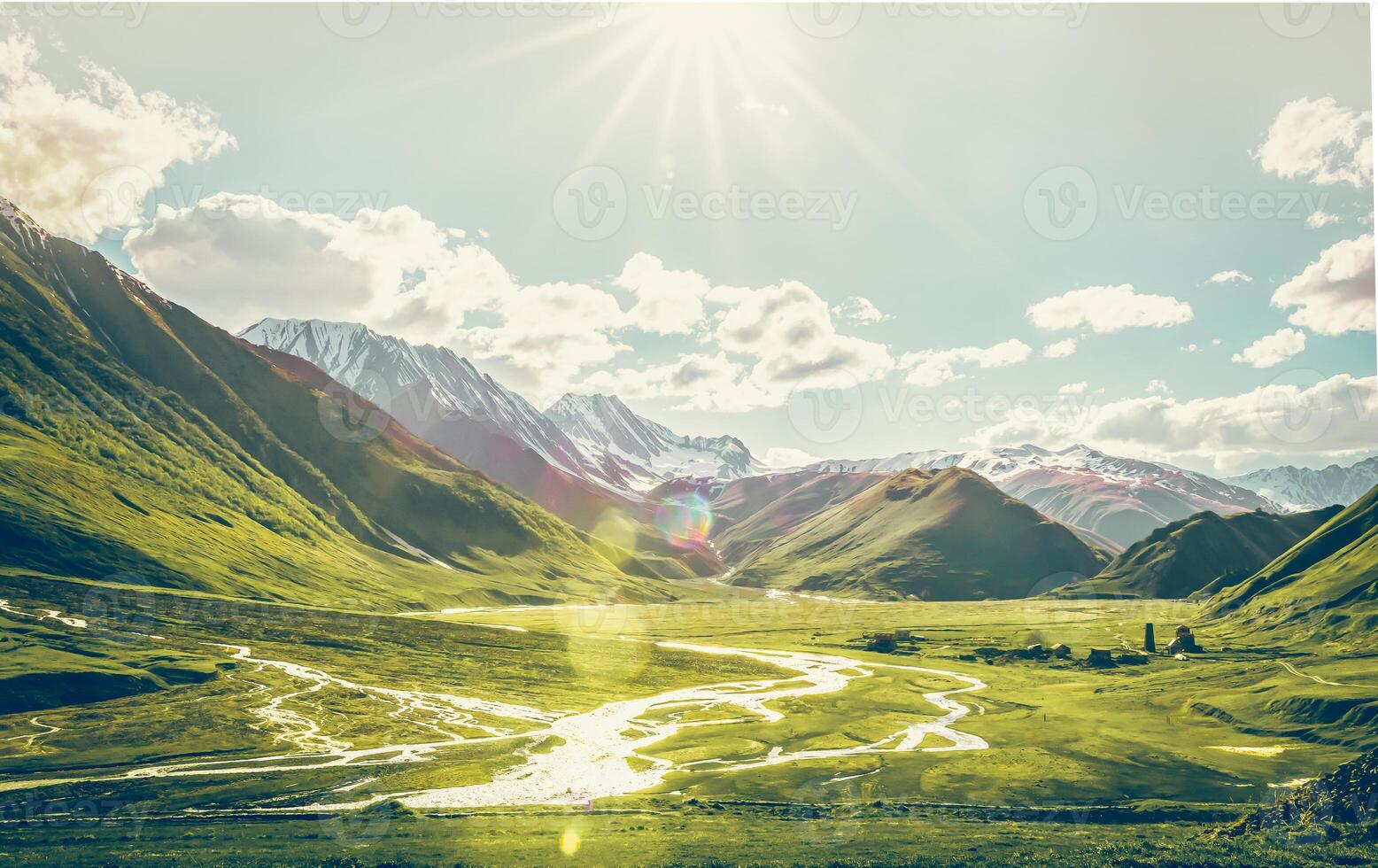 Dramatic panoramic landscape view of the mountains, river and cloudy sky with sun flare in the sky. Truso valley. Kazbegi. Travel in Georgia photo