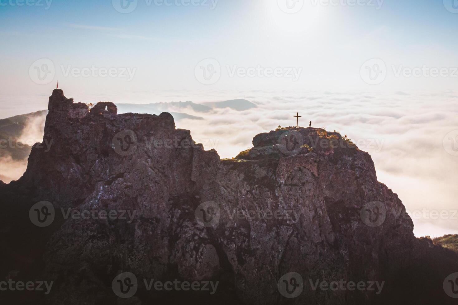 Dramatic aerial view of Kojori fortress above the cloudscape with person silhouette figure on top standing victorious photo