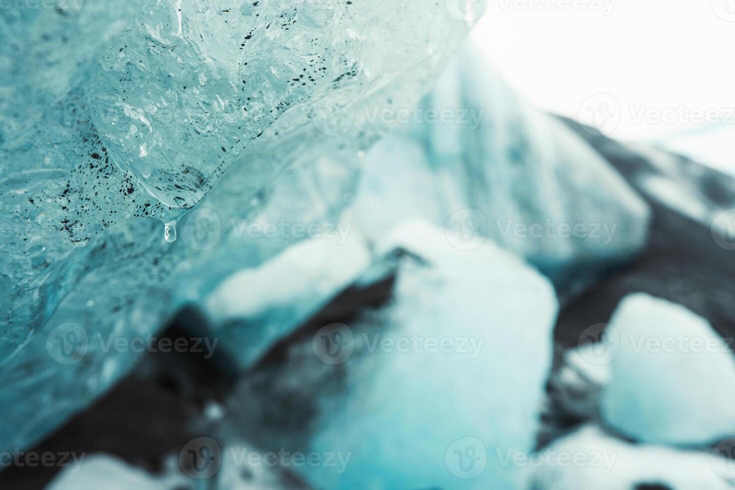 Close up Fjallsjokull glacier icebergs in overcast rainy day in Iceland with water drops. The wonderful glacier lagoon of Fjallsrln in Iceland photo