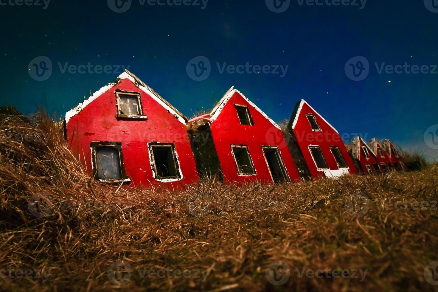 Traditional Icelandic tiny imitation Turf Houses. A row of traditional Icelandic houses with the roofs covered in turf for insulation photo