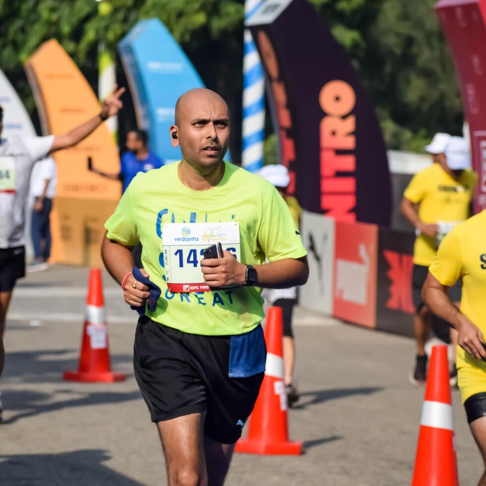 New Delhi, India - May 15 2024 - Vedanta Delhi Half Marathon race after covid in which marathon participants about to cross the finish line, Delhi Half Marathon 2023 photo