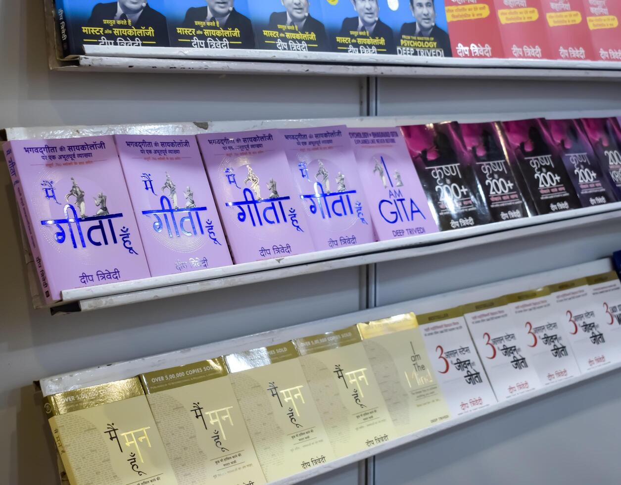 New Delhi, India, February 17 2024 - Variety of Books on shelf inside a book-stall at Delhi International Book Fair, Selection of books on display in Annual Book Fair at Bharat Mandapam complex photo