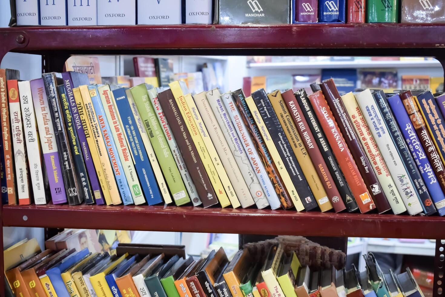 New Delhi, India, May 31 2024 - Variety of Books on shelf inside a book-stall at Delhi International Book Fair, Selection of books on display in Annual Book Fair at Bharat Mandapam complex photo
