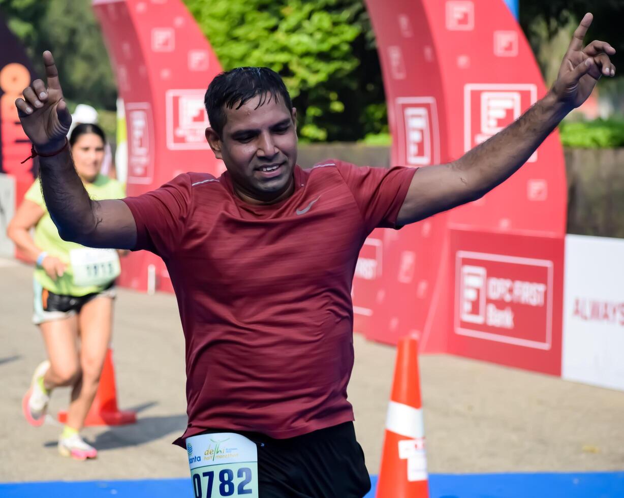 New Delhi, India - May 31 2024 - Vedanta Delhi Half Marathon race after covid in which marathon participants about to cross the finish line, Delhi Half Marathon 2023 photo