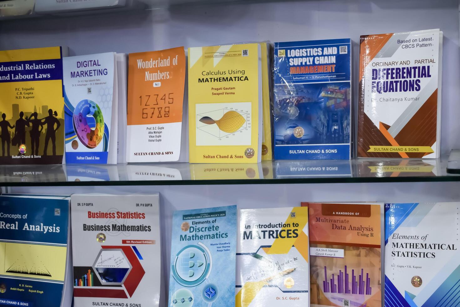 New Delhi, India, May 17 2024 - Variety of Books on shelf inside a book-stall at Delhi International Book Fair, Selection of books on display in Annual Book Fair at Bharat Mandapam complex photo