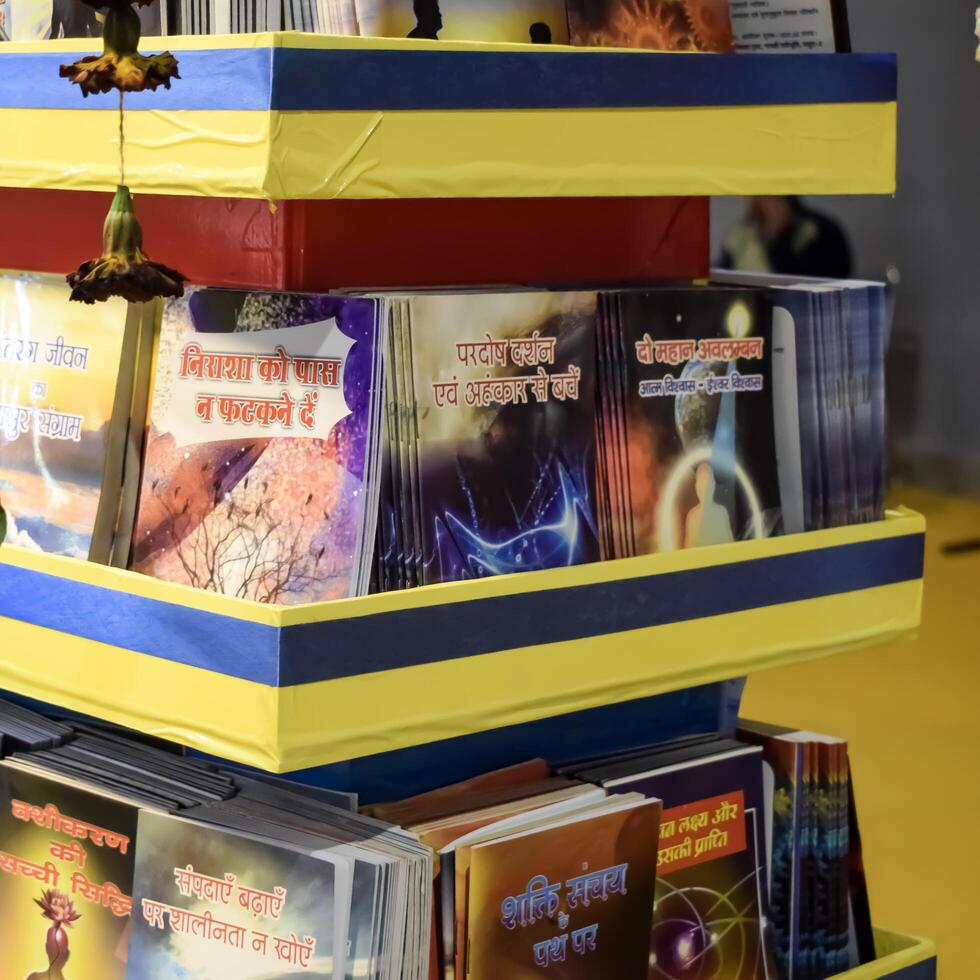 New Delhi, India, May 17 2024 - Variety of Books on shelf inside a book-stall at Delhi International Book Fair, Selection of books on display in Annual Book Fair at Bharat Mandapam complex photo