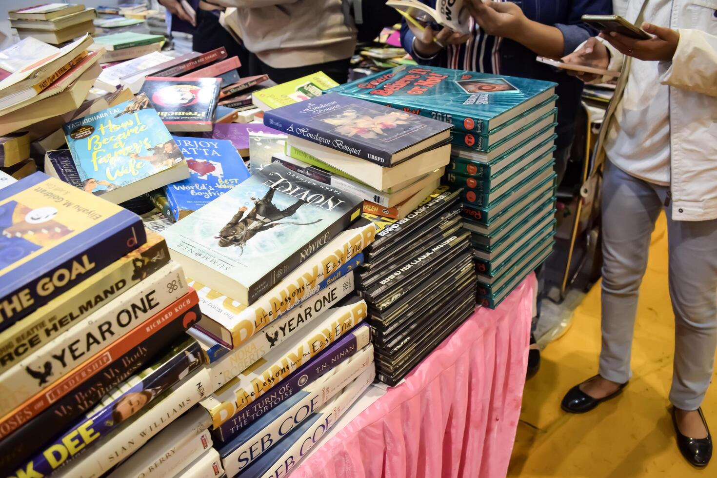 New Delhi, India, May 17 2024 - Variety of Books on shelf inside a book-stall at Delhi International Book Fair, Selection of books on display in Annual Book Fair at Bharat Mandapam complex photo
