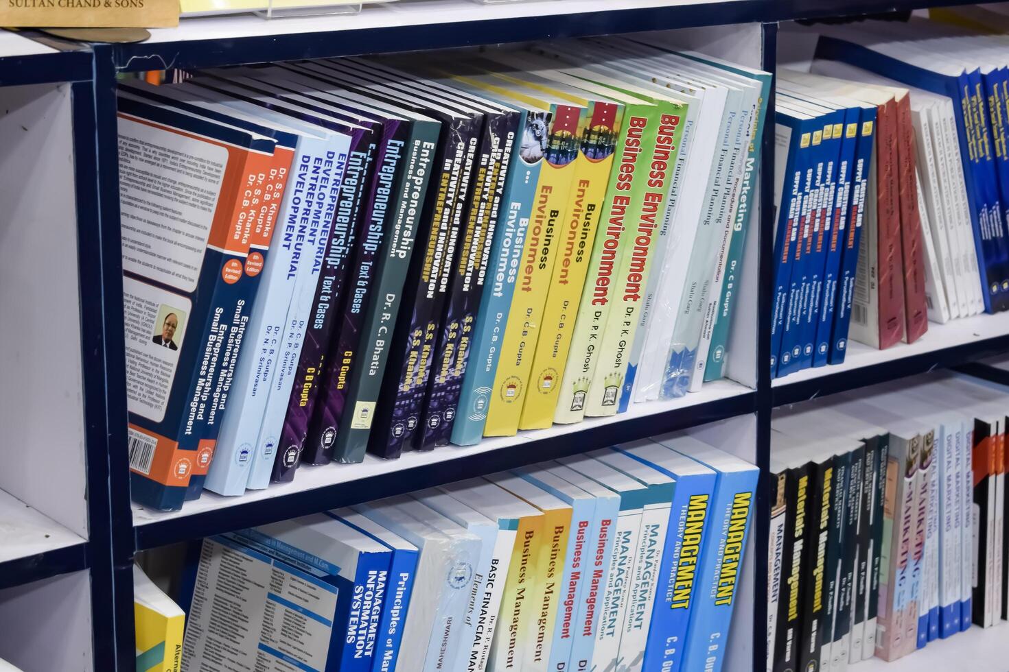 New Delhi, India, February 17 2024 - Variety of Books on shelf inside a book-stall at Delhi International Book Fair, Selection of books on display in Annual Book Fair at Bharat Mandapam complex photo