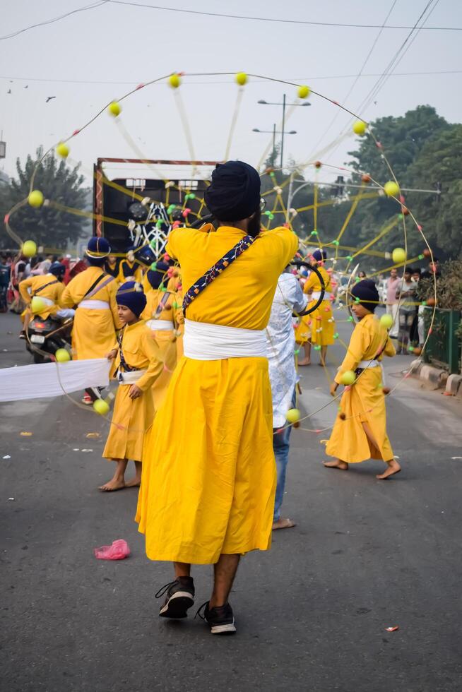 Delhi, India, May 2, 2024 - Sikhs display gatka and martial arts during annual Nagar Kirtan, Traditional, procession on account of birthday of Guru Nanak Dev ji, Nagar Kirtan in East Delhi area photo
