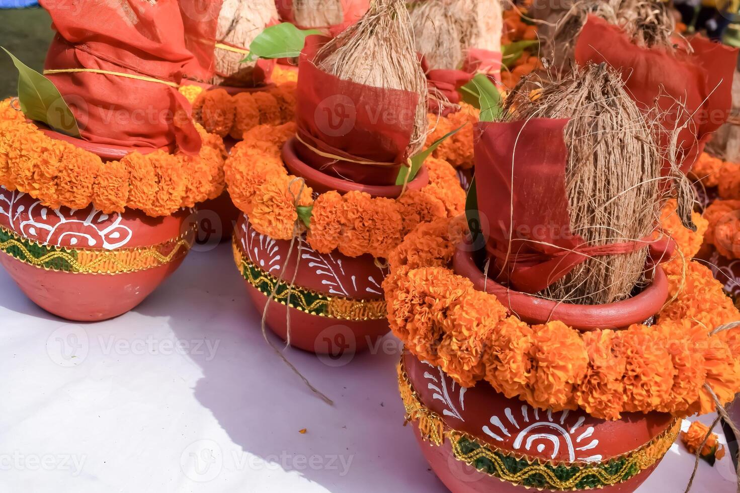 Kalash with coconut and mango leaf with floral decoration earthen pots containing sacred water. Kalash for hindu puja during Jagannath Temple Mangal Kalash Yatra, front view, closeup photo