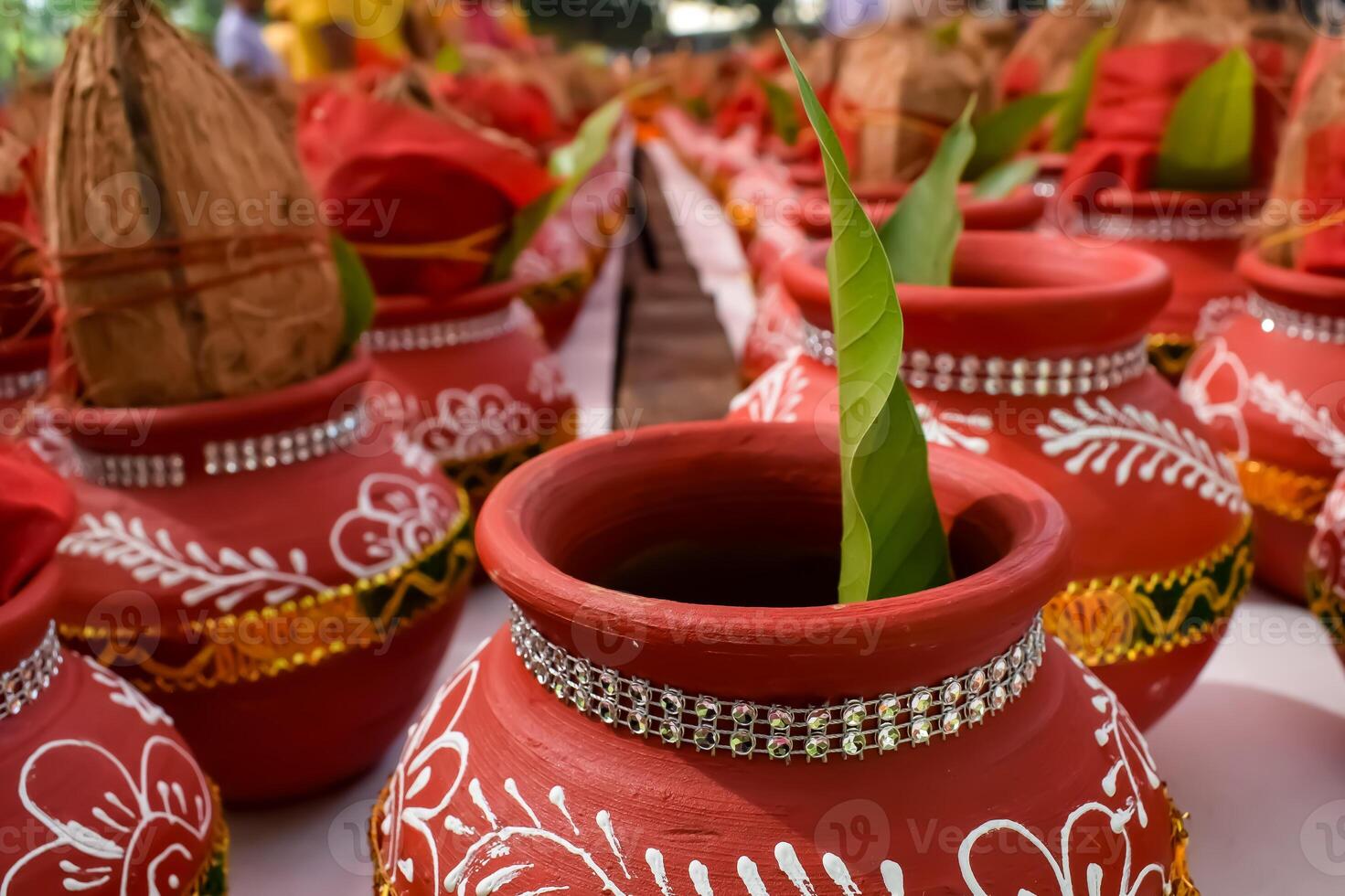 Kalash with coconut and mango leaf with floral decoration earthen pots containing sacred water. Kalash for hindu puja during Jagannath Temple Mangal Kalash Yatra, front view, closeup photo