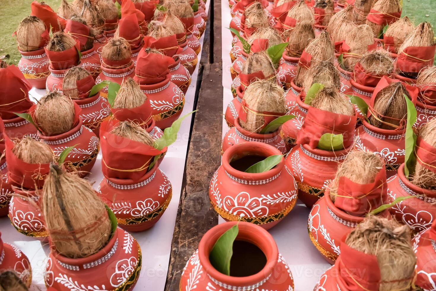 Kalash with coconut and mango leaf with floral decoration earthen pots containing sacred water. Kalash for hindu puja during Jagannath Temple Mangal Kalash Yatra, front view, closeup photo