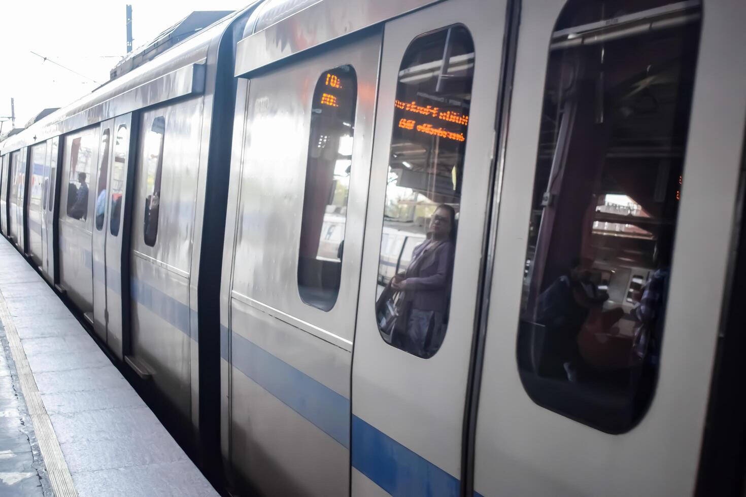 New Delhi, India, May 12 2024 - Delhi Metro train arriving at Jhandewalan metro station in New Delhi, India, Asia, Public Metro departing from Jhandewalan station photo