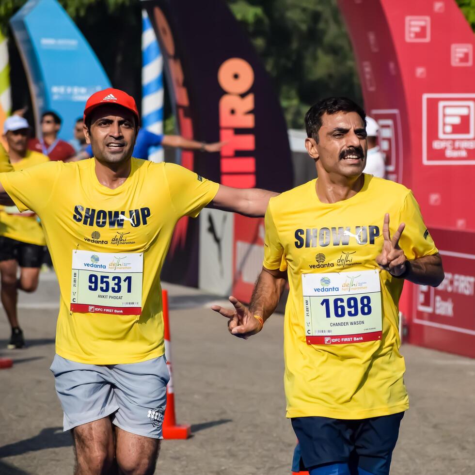 New Delhi, India - May 5 2024 - Vedanta Delhi Half Marathon race after covid in which marathon participants about to cross the finish line, Delhi Half Marathon 2023 photo
